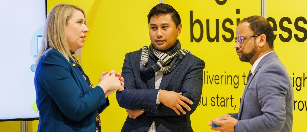 Group of three people talking and the CommBank SMB Expo