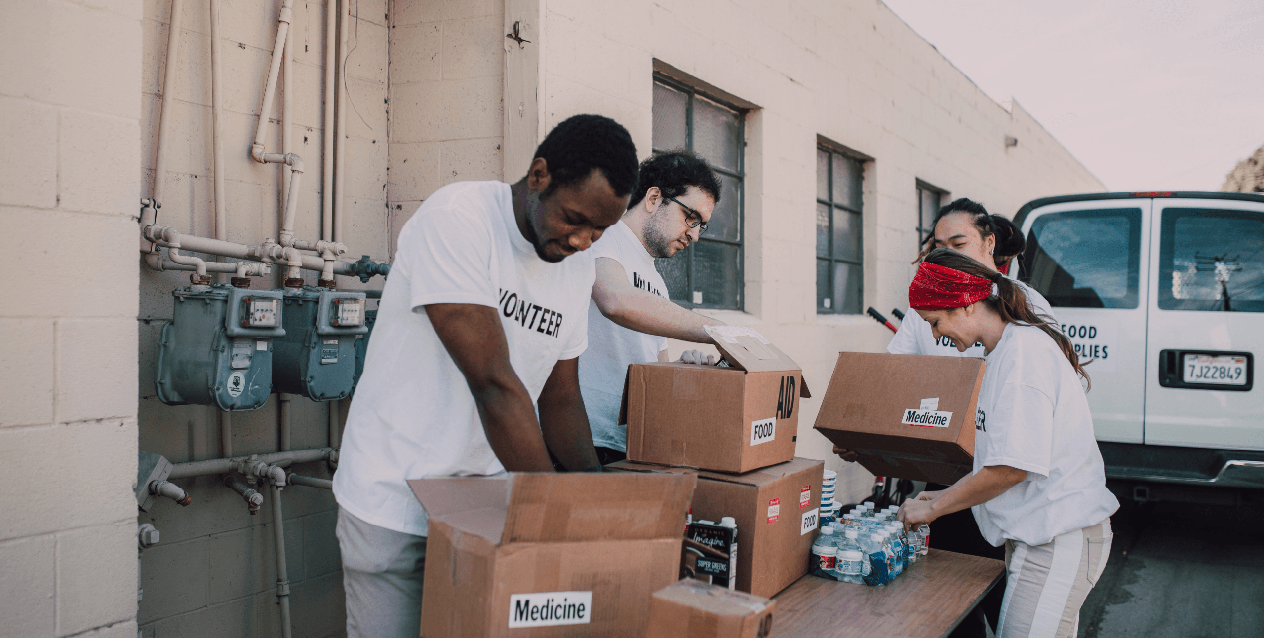 Volunteers packing boxes labelled food and medicine