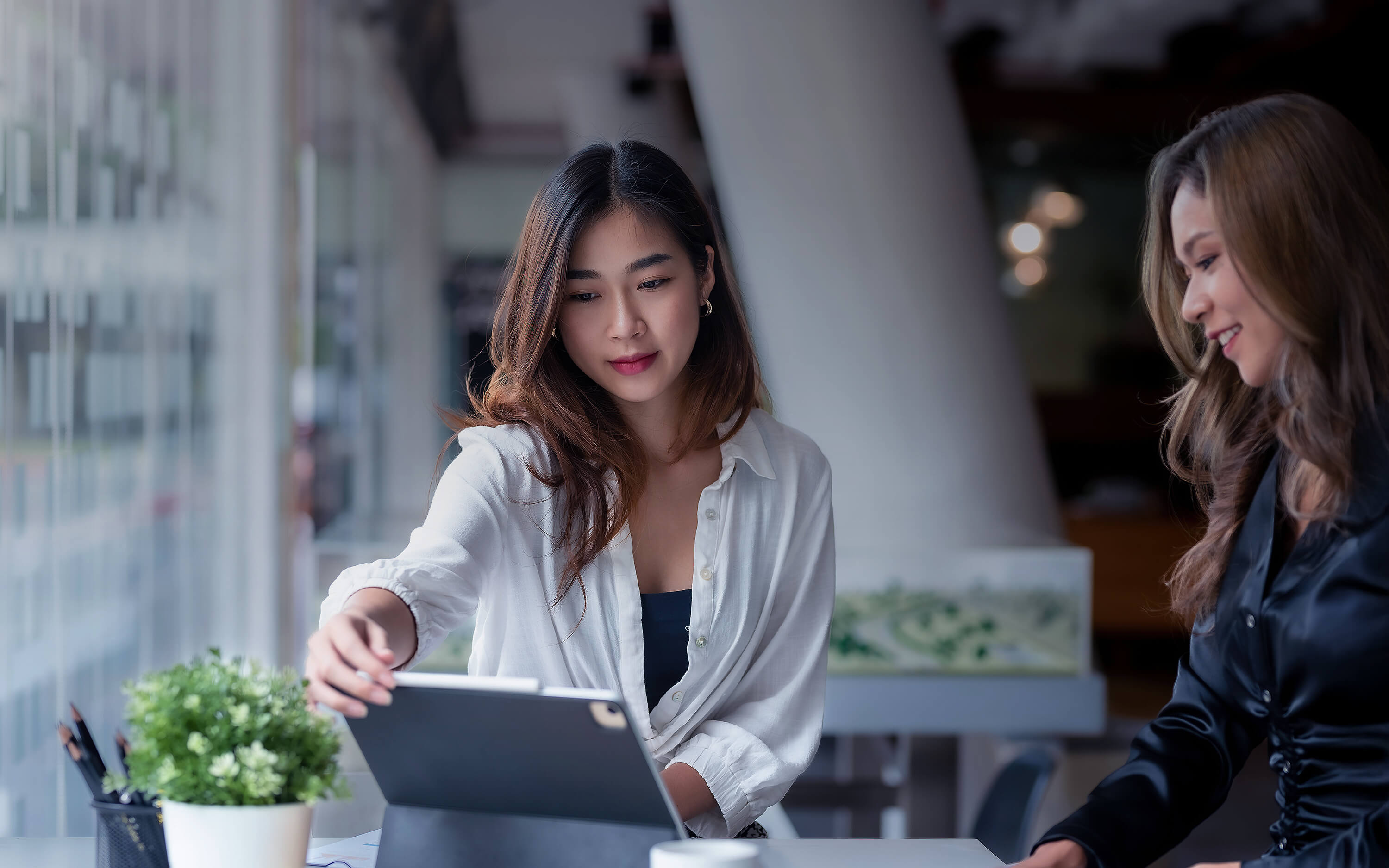 Two Women working on a computer