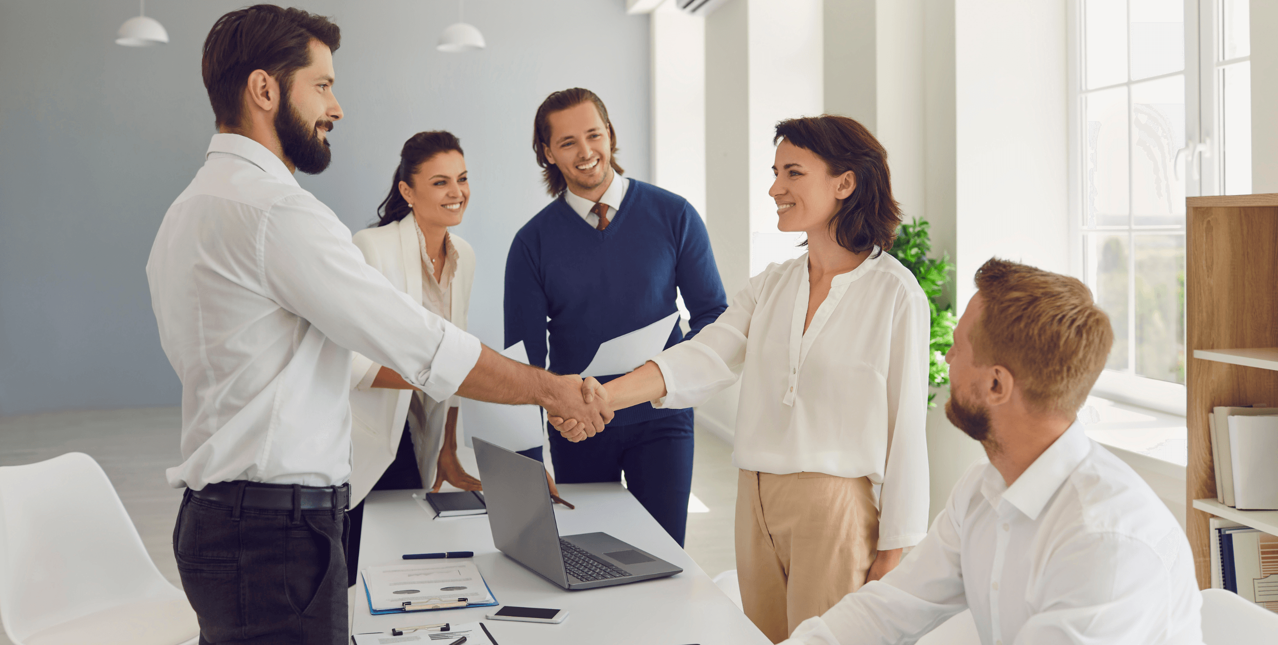 People shaking hands over a deal
