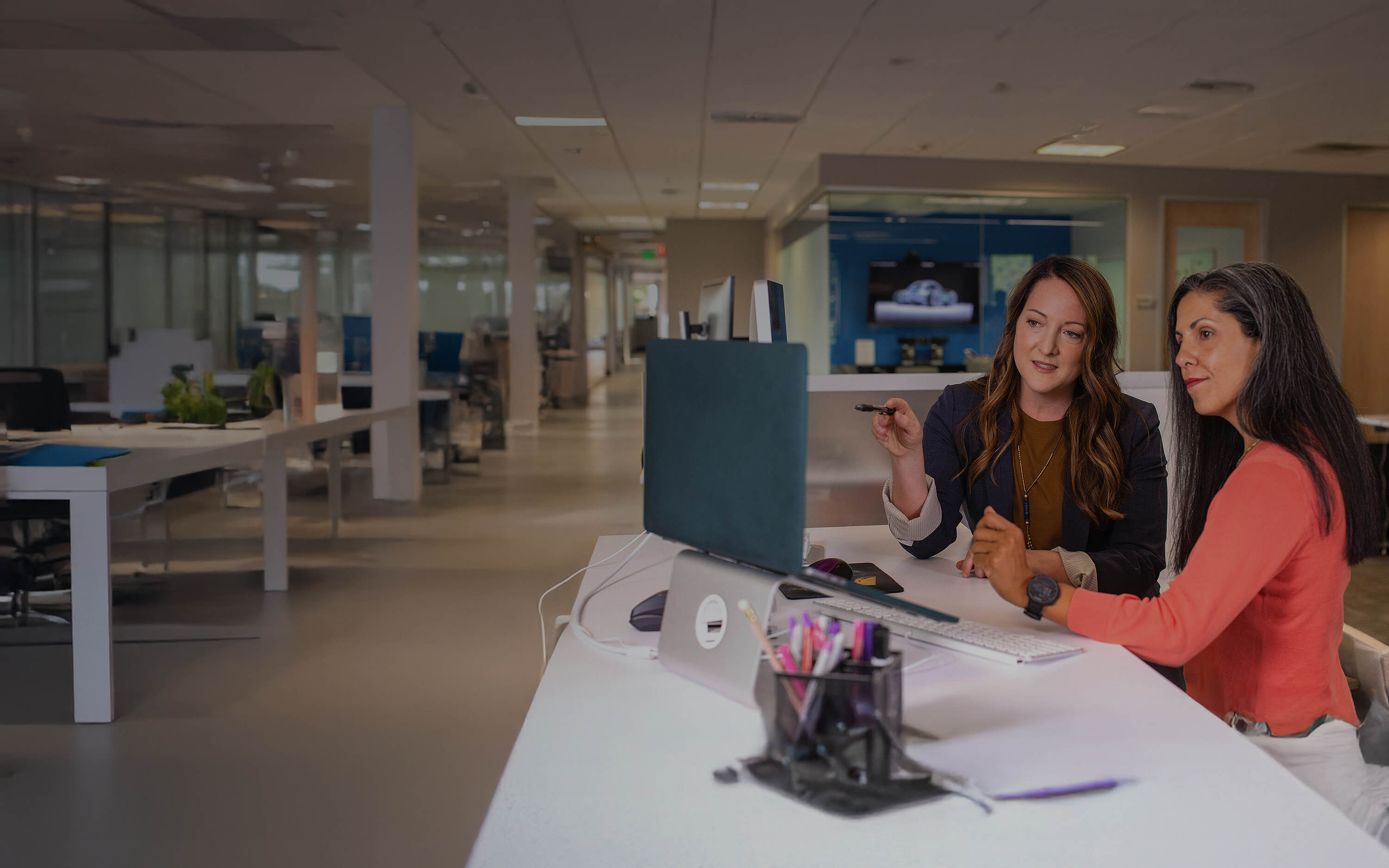 Someone teaching another person how to do something on their computer