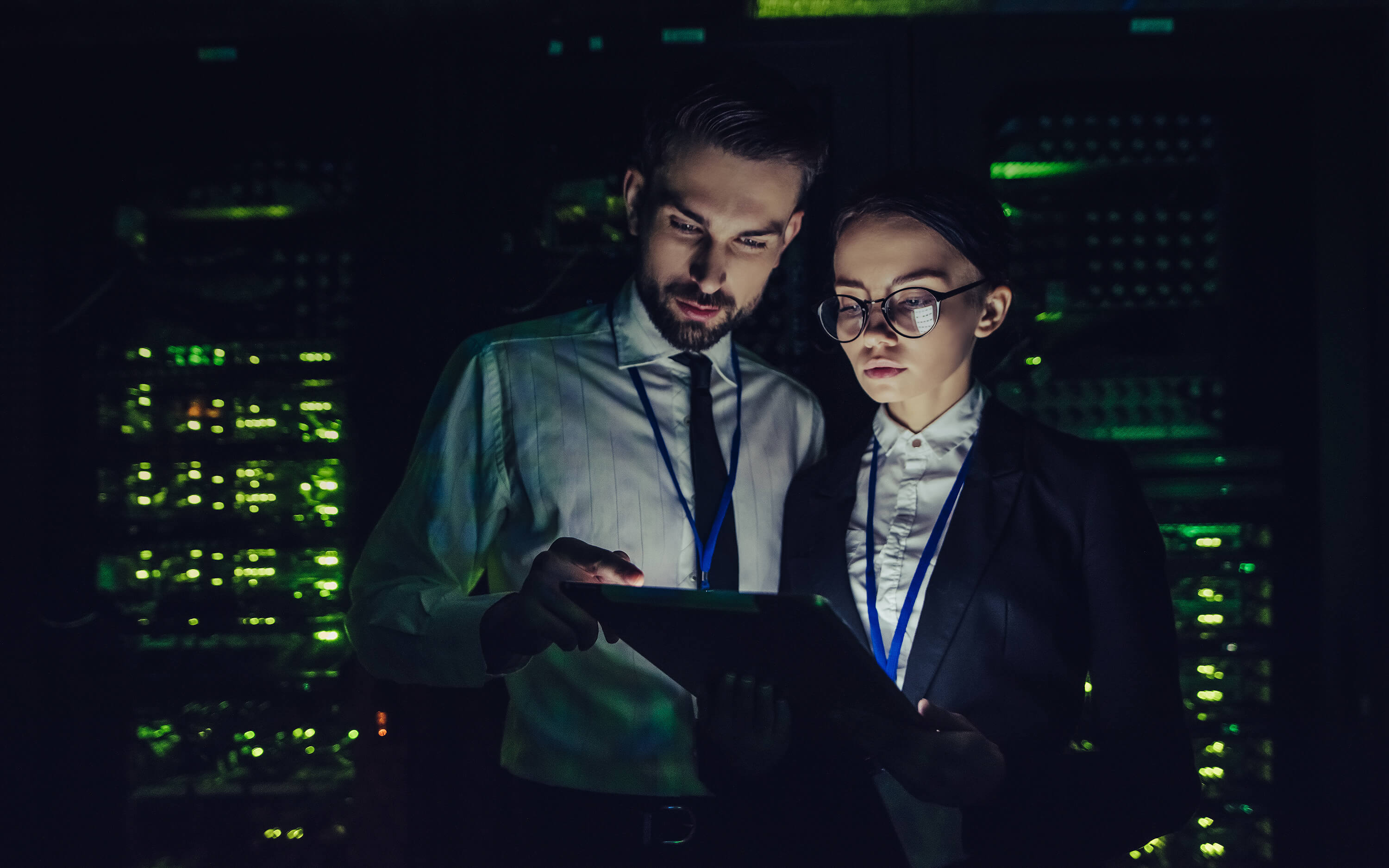 People working in a dark data centre