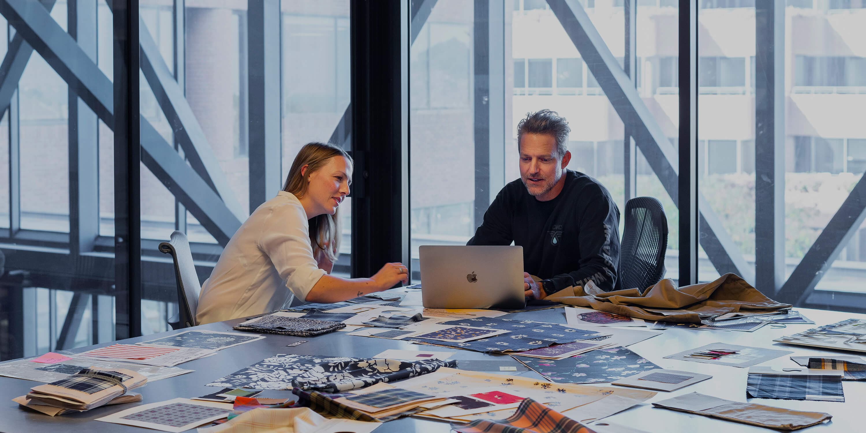 People working with fabric swatches on table