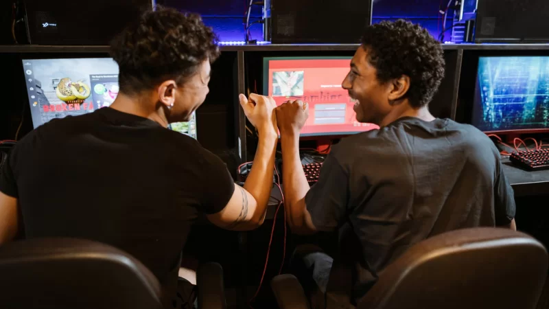 two friends celebrating a win on a game